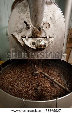 The arms of a coffee roasting machine turn to help the beans roast evenly.