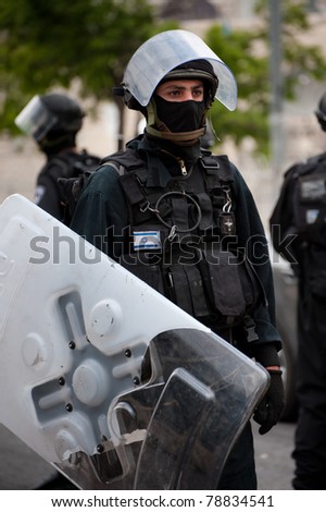 JERUSALEM - MAY 15: Unidentified Israeli riot police patrol streets on the Mount of Olives in East Jerusalem following clashes on Nakba Day on May 15, 2011 in Jerusalem, Israel.