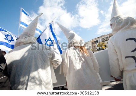 TEL AVIV - DECEMBER 9: Israeli activists dress as KKK members to satirize right-wing Israeli policies and politicians during in the annual human rights march in Tel Aviv on Dec 9, 2011.