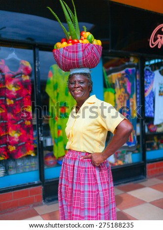 SAINT ANN, NORTH COAST OF JAMAICA - APRIL 2, 2008: Local fruits trader is greeting buyers on a market place.