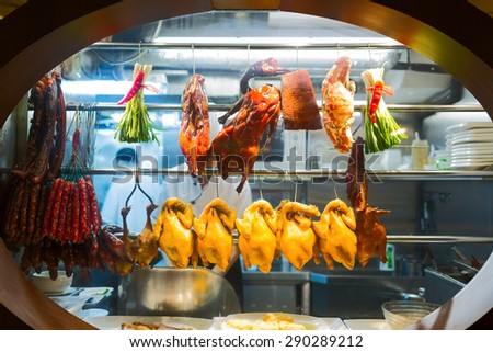 Smoked duck, chicken and meat are exposed on the kitchen's window. Chinese restaurant