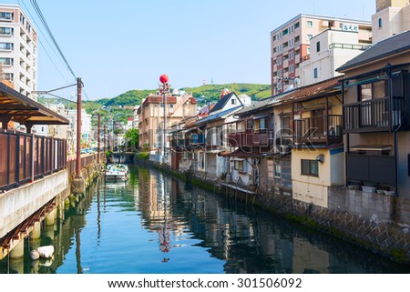 NAGASAKI CITY, JAPAN - 19 MAY 2013: Old Town district in Nagasaki City. Artificial canal flows into the Japanese Sea. Nagasaki, Japan.