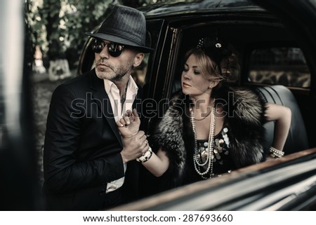 Retro couple with black old car