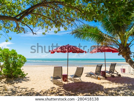 turquoise sea, deckchairs, white sand and palms, sun