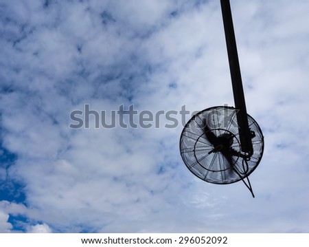 big electronic fan for outdoor using in silhouette with propelle