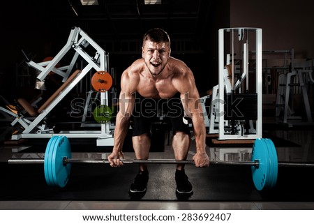 Muscular Men Lifting Deadlift In The Gym
