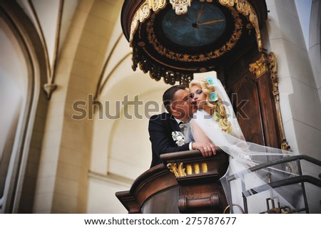 Young beautiful wedding couple at the old catholic church