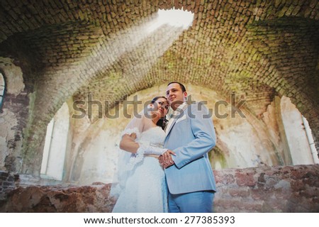 Just married wedding couple on old castle sun ray