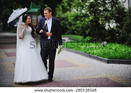 wedding couple on the  background bridge under umbrella