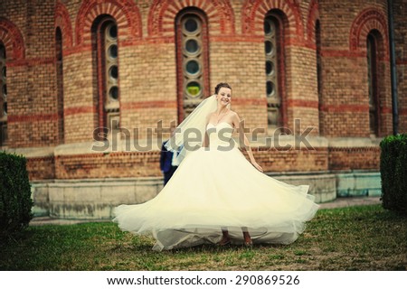 bride dance with her dress near vintage building