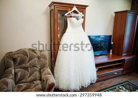 white wedding dress on decorated hangers