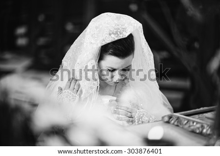 Bride in church under cover shawls