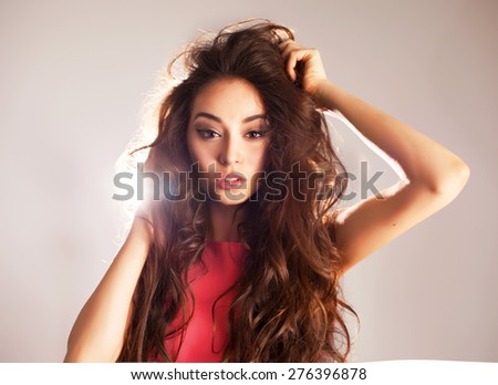 Portrait of beautiful brunette woman studio lights.young pretty  model with long hair and big full bright lips natural make up,studio lights,fashion stylish trendy woman,dress,collections,emotions