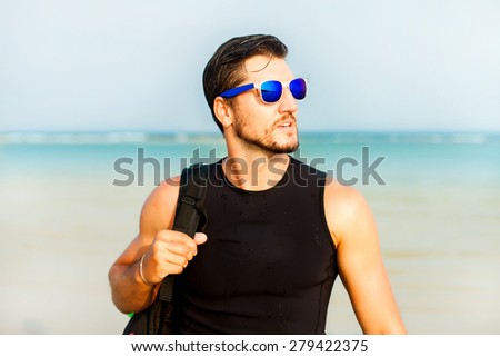 Adventure man hiking wilderness serf with backpack, outdoor lifestyle survival vacation,Portrait of bearded man with sunglasses,travel bag and reflecting sunglasses,behind the ocean view