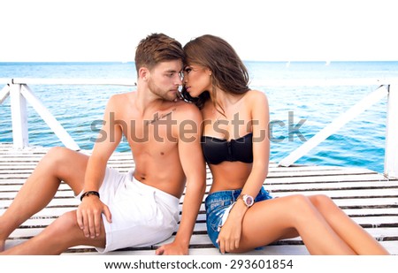 Summer stylish fashion sensual portrait of a happy, sexy couple in love.Gorgeous, young, beautiful lovers, on vacation in a tropical country. Kissing and hugs.couple love,people in love,fitness couple