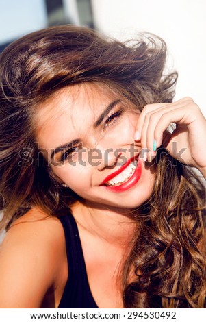 Close-up lifestyle portrait of Young pretty teen girl with perfect skin stylish hairstyle,posing on urban background,bright summer fashion portrait.Smiley face,amazing smile,sensual,accessories,bright