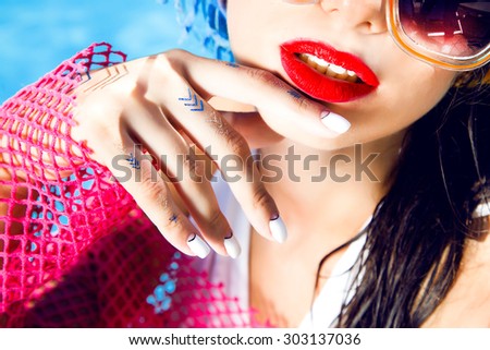 Outdoor fashion portrait of young sexy woman with perfect nail polish,gold flash tattoo,Nice sunny summer hot day.bright summer colors,wet hair,shellac,accessory,jewelry,mouth,red lips,toned,tan skin