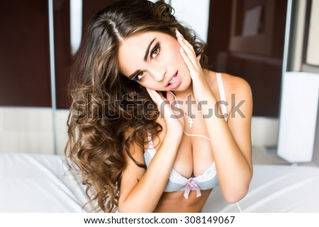 Close up portrait smiling pretty young woman,long healthy fluffy hairs,natural make up,perfect skin,positive emotions,happiness,soft vintage colors.Joy time with favorite music,earphones,lingerie