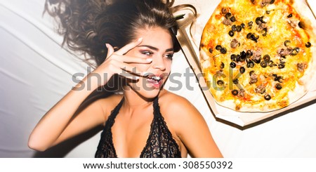 Party time,happy mood,positive emotions,laughing teenage girl.Happy woman holding tasty piece of spicy pizza with cheese.waiting for friends at home,han-party,pajama party,girls holiday,laughing,smile