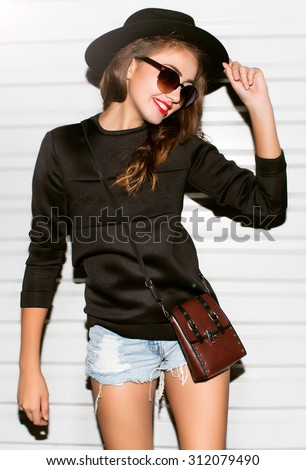 Lifestyle cool portrait,fashionable hipster woman wear autumn outfit,school uniform,fashion look.Teen hipster girl going crazy,positive surprised emotions,screaming and laughing,bright black outfit