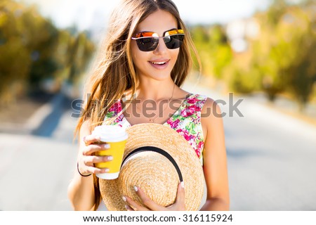 Laughing portrait of sensual woman drinking coffee on the city street,summer sale,travel concept,cute trendy glamour outfit,drinking hot latte,smiling enjoy weekends,travel with straw hat,cappuccino