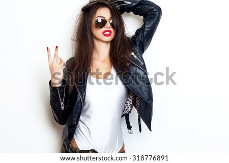 Pretty young sexy fashion sensual woman posing on white wall background dressed in hipster style jeans outfit,Stylish fashionable blonde girl hipster in black clothes.White background,not isolated