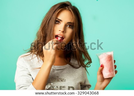 Beauty Girl Portrait with Colorful Makeup,Nail polish and Accessories. Studio Shot of Funny Woman. Vivid Colors. Colourful Manicure and fashion Hairstyle. Rainbow Colors. Beautiful lady make up,candy
