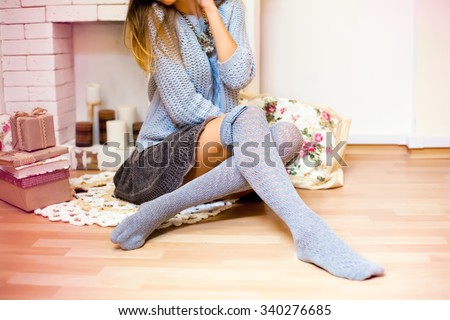Soft image of stylish teen girl wear winter outfit,portrait of woman celebrate hanukkah and christmas with presents,share gifts,cute outfit with warm clothing,grey socks,knitted sweater,with deers
