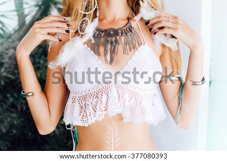 Close-up lifestyle image of woman,wearing trendy wool bohemian style,bohemian boho style,hippie chic vibe,gypsy fashion indie folk dress,stylish vintage bohemian outfits.Fall fashion,earrings,necklace