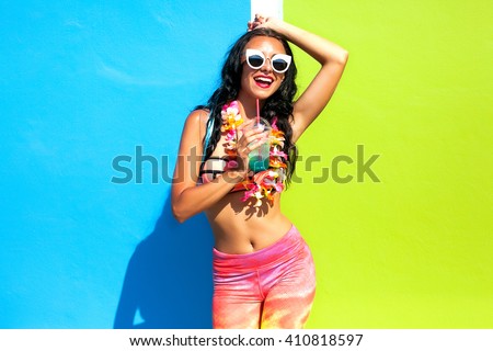 Close up fashion portrait of young fashionable woman in summer outfit,sunglasses.Miami street during summer holidays, attractive funky female posing with fresh detox smoothie cocktail,smiling laughing
