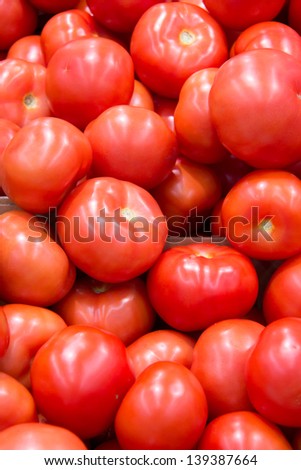 many ripe tomatoes. laid out on the counter on the market for sale.