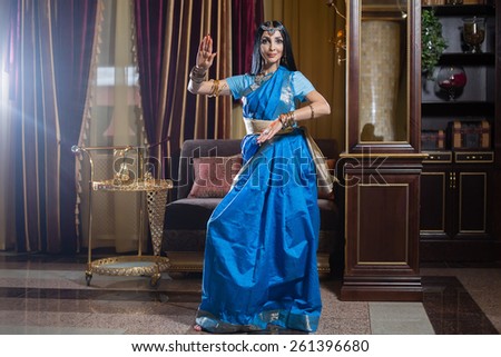 Caucasian woman is dancing in traditional indian dress