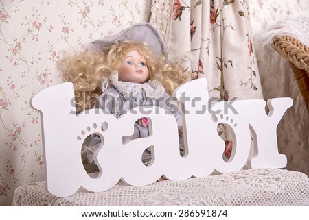 the word baby bright letters with the doll in the background