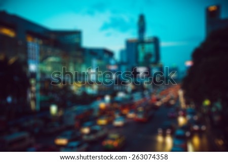 people in bokeh, street of night Bangkok, roadway in the city