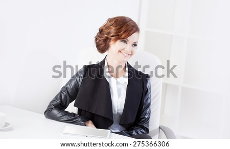 Successful business woman looking to the right and smiling, close up