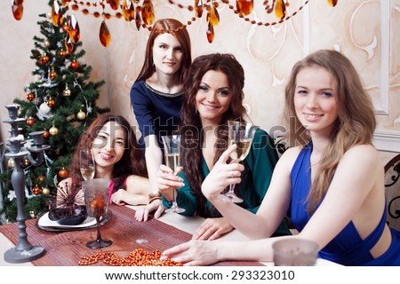 Two friends on a party, girl sitting at the holiday table