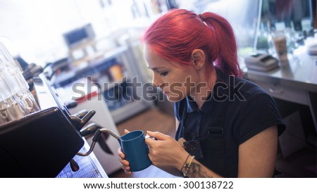 young girl Barista prepares coffee in pub, bar, restaurant