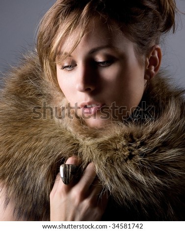 The young beautiful girl in a fur collar