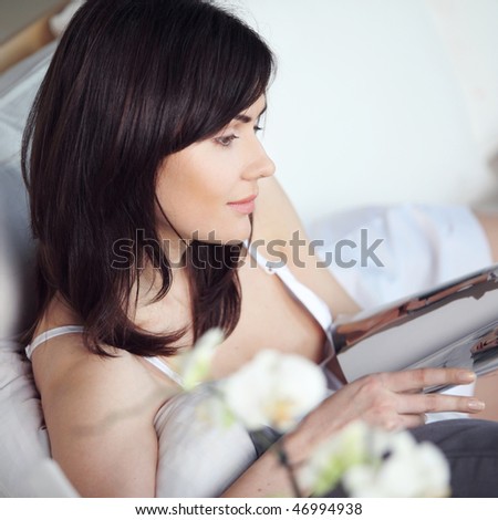 young beautiful girl reads magazine