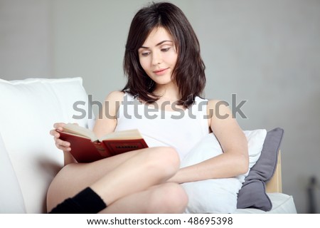 Reading the book, young beautiful girl reads book