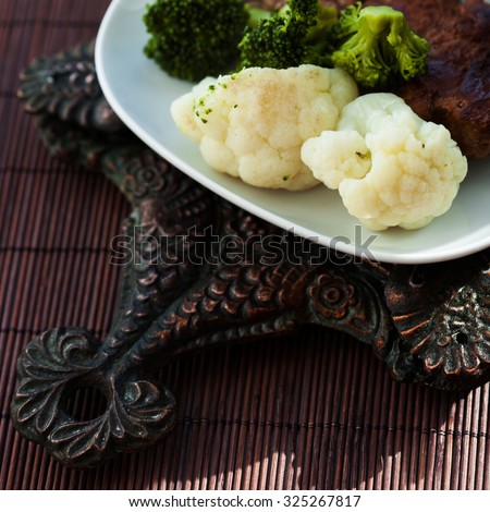 homemade food. Meat steamed with cauliflower and broccoli, top view