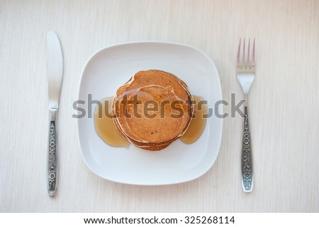 Stack of pancakes with  maple syrup, top view
