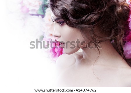 Portrait of a beautiful fashion girl, sweet and sensual. Beautiful makeup and messy romantic hairstyle. Flowers background.