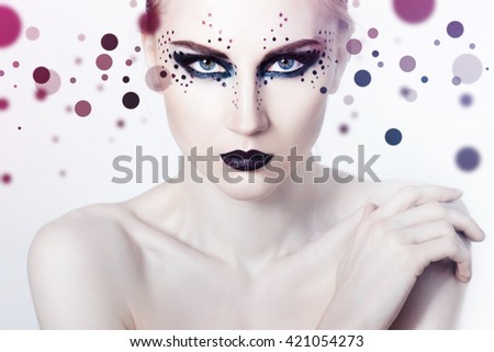 Beauty Fashion Model Girl with smoky eyes and black lips. Dots background