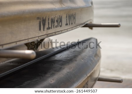 Canoes on a boat rental rack at a lake.