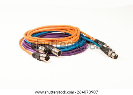 3 colored XLR microphone cables coiled together showing both male and female connectors, isolated on a white background.