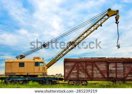 cargo crane old rusty freight car on the green grass