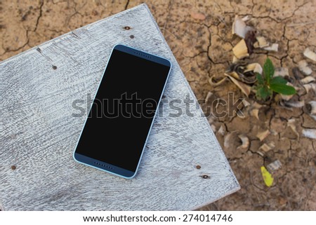 Mobile smart phone on the table outdoor.