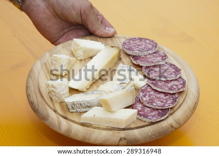 Mixed cheeses wooden platter and salami, italian food
