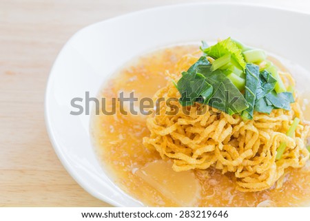 Fried noodle with pork on tableware.